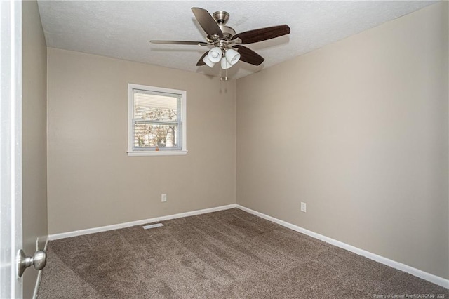 carpeted empty room with ceiling fan, baseboards, and a textured ceiling