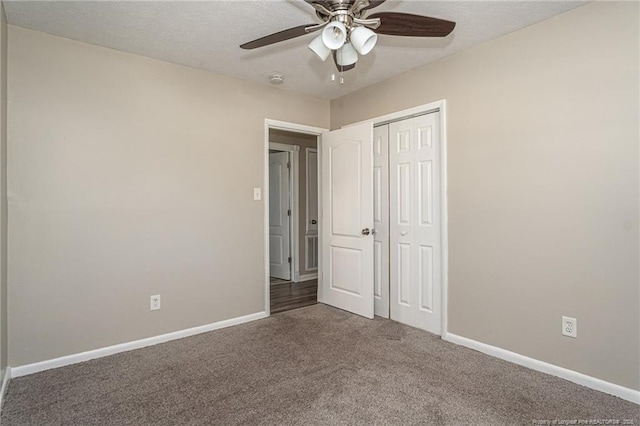 unfurnished bedroom featuring a closet, baseboards, carpet, and a textured ceiling