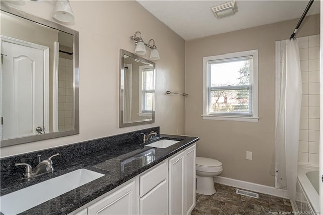 bathroom featuring a sink, visible vents, and toilet