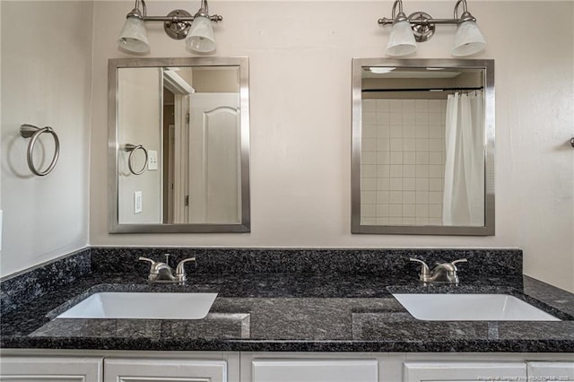 full bath with a sink and double vanity