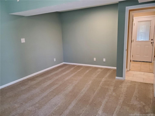 tiled empty room with baseboards and carpet floors