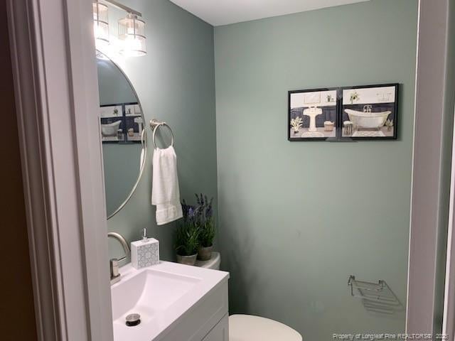 bathroom featuring toilet and vanity