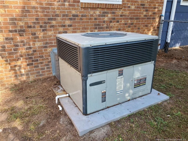 details with mail area, central AC unit, and brick siding