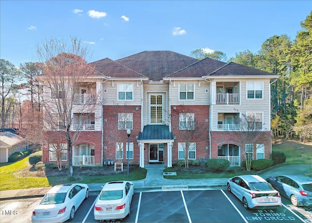 view of building exterior featuring uncovered parking