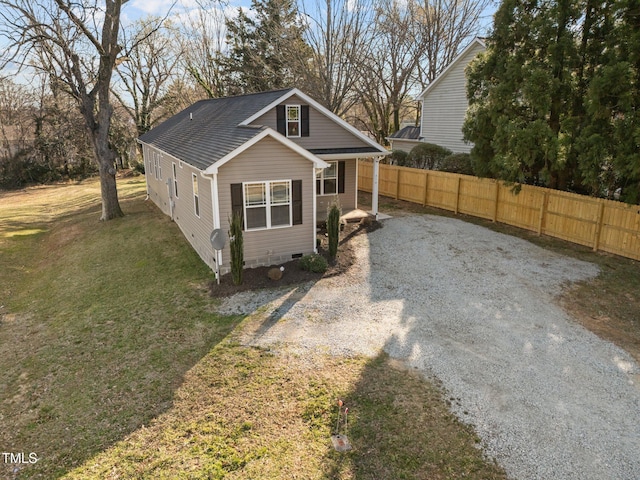 view of front of house with a shingled roof, a front yard, fence, and crawl space