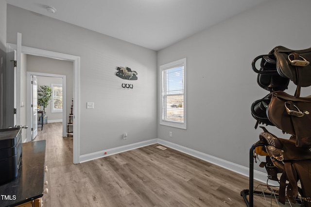 interior space featuring baseboards and wood finished floors