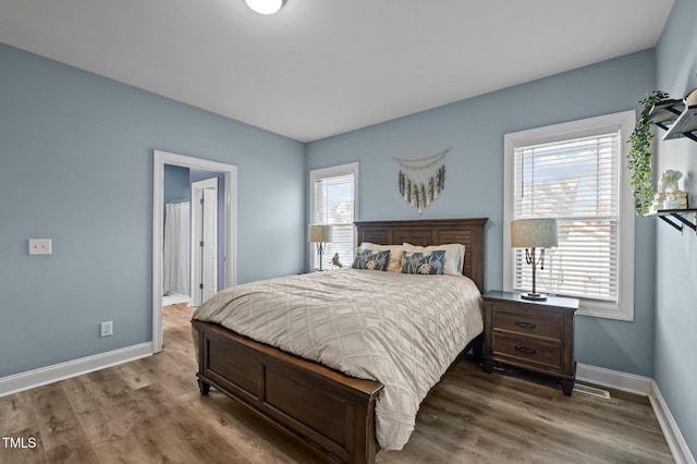 bedroom featuring baseboards and wood finished floors