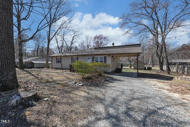 view of front facade with a carport and an outdoor structure