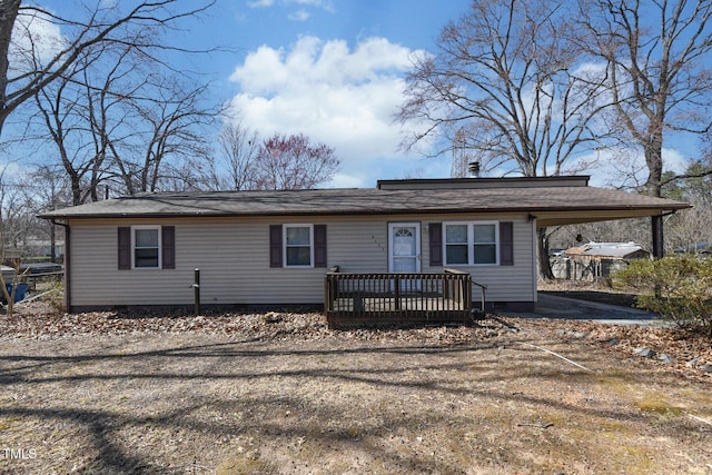 view of front of property with an attached carport and crawl space