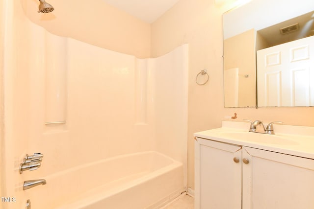 bathroom with bathtub / shower combination, vanity, and visible vents