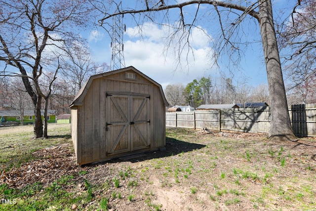 view of shed featuring fence