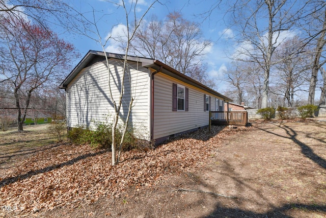 view of home's exterior featuring a deck and crawl space