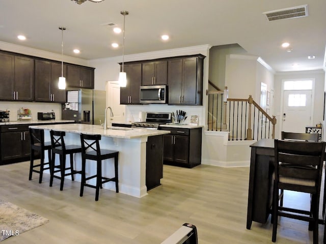 519 Flat Ford Rd, Hillsborough, NC 27278 - kitchen featuring a kitchen breakfast bar, stainless steel appliances, ornamental molding, a sink, and visible vents