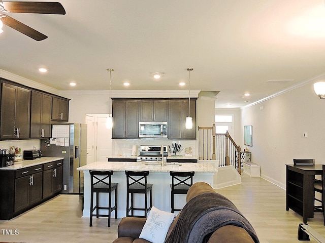 519 Flat Ford Rd, Hillsborough, NC 27278 - kitchen with stainless steel appliances, a breakfast bar, backsplash, a ceiling fan, and a kitchen island with sink