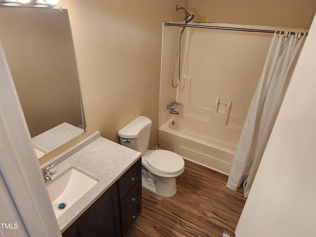 bathroom featuring shower / tub combo, toilet, wood finished floors, and vanity