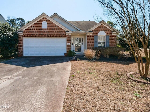 ranch-style home with an attached garage, brick siding, and driveway