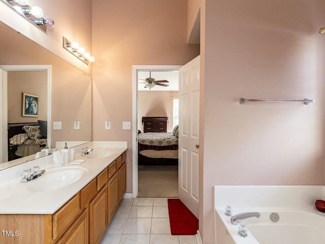 ensuite bathroom with a sink, a garden tub, ensuite bathroom, and tile patterned floors