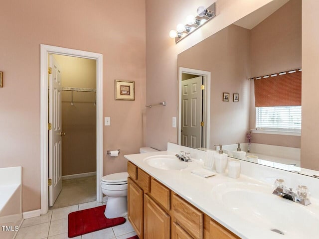 full bath featuring tile patterned flooring, toilet, a garden tub, and a sink