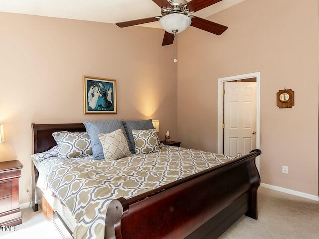 bedroom featuring light colored carpet, baseboards, and ceiling fan