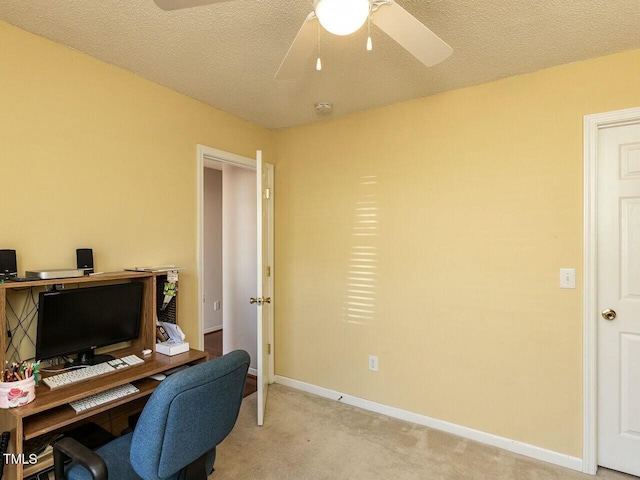 office with baseboards, light carpet, a textured ceiling, and ceiling fan