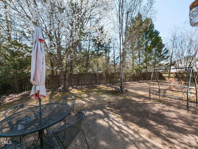 view of yard with outdoor dining space and a fenced backyard