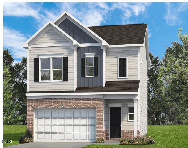 craftsman house with board and batten siding, concrete driveway, a front yard, an attached garage, and brick siding