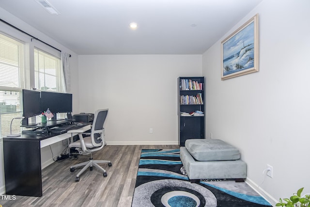 office featuring visible vents, baseboards, and wood finished floors