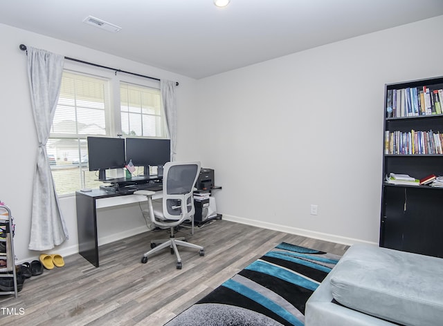 office with wood finished floors, visible vents, and baseboards