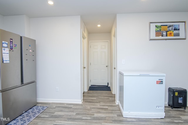 interior space with recessed lighting, baseboards, and light wood finished floors