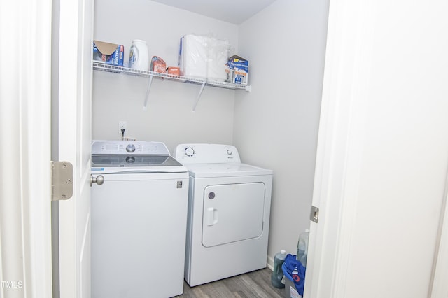 laundry area featuring washing machine and clothes dryer, laundry area, and light wood finished floors