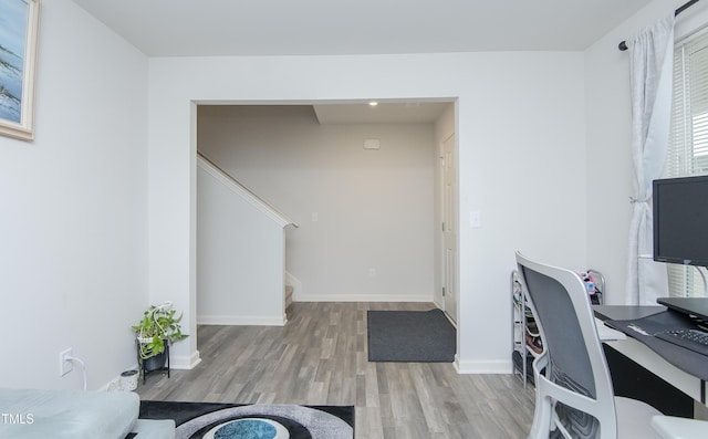 office area featuring baseboards and wood finished floors