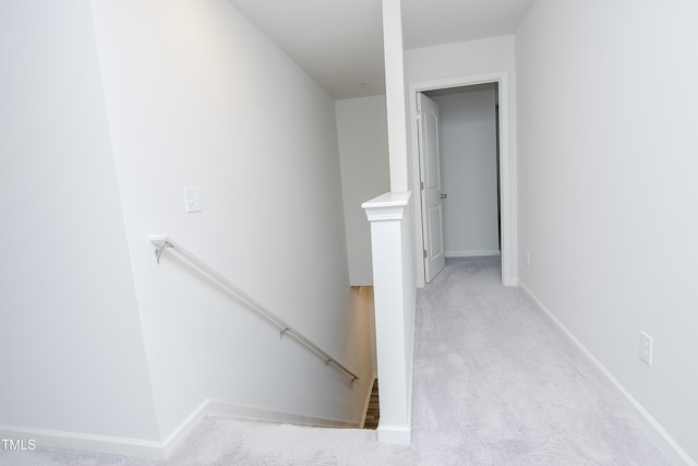 stairs featuring baseboards and carpet flooring