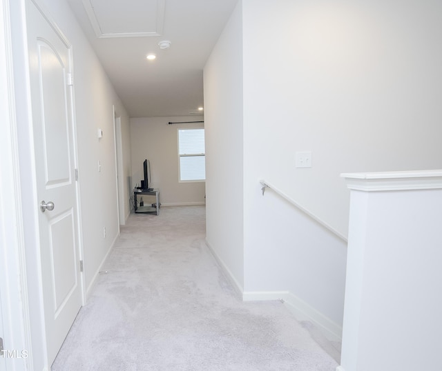 hallway with recessed lighting, baseboards, an upstairs landing, and light carpet