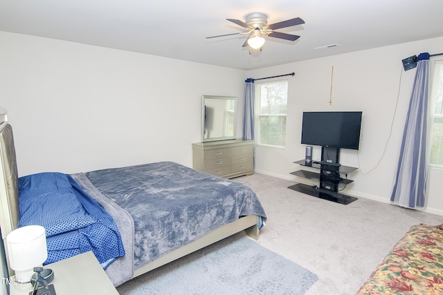 bedroom with carpet flooring, a ceiling fan, and baseboards