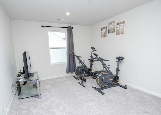 exercise room with carpet, baseboards, and visible vents