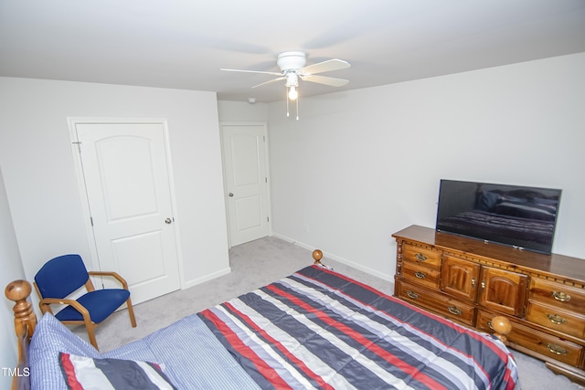 bedroom with ceiling fan, baseboards, and light carpet