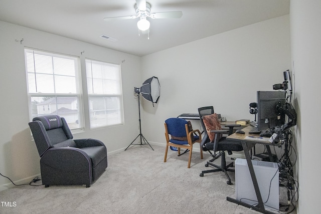 office space with baseboards, carpet, visible vents, and ceiling fan