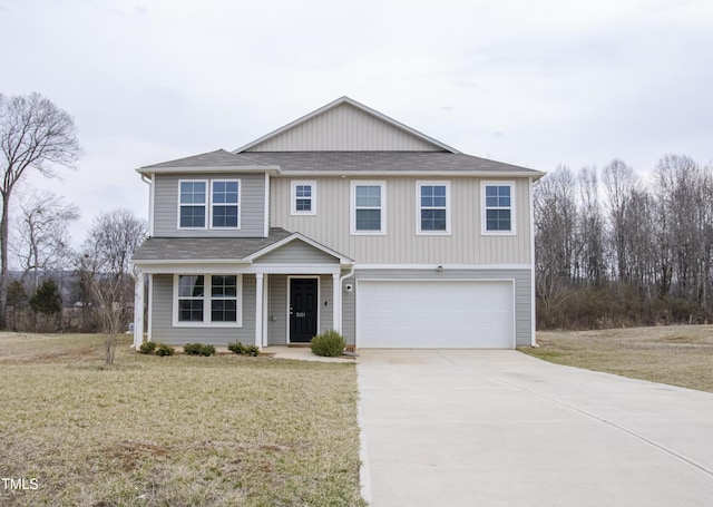 2121 Wildwind Dr, Graham, NC 27253 - traditional-style house featuring a garage, roof with shingles, concrete driveway, and a front yard