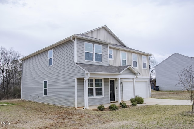 view of front facade with a front lawn, concrete driveway, and an attached garage