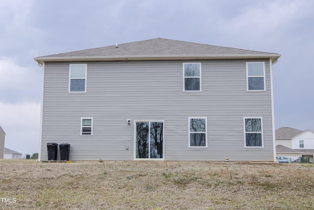 rear view of property with central AC