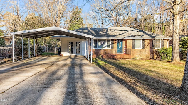 single story home with driveway, fence, french doors, a front yard, and brick siding