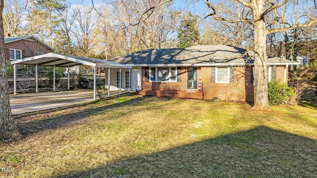 view of front of home with brick siding, concrete driveway, and a front yard