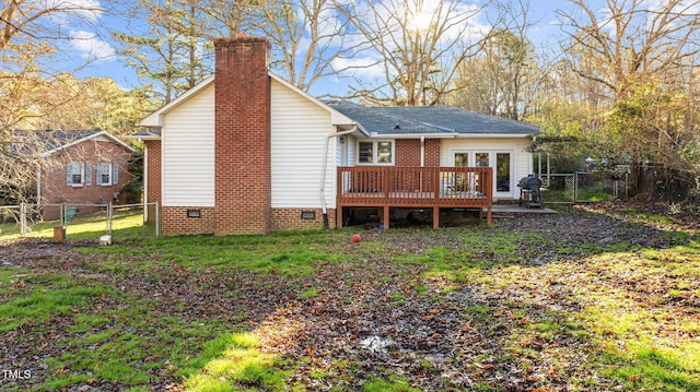 rear view of house with crawl space, a wooden deck, french doors, and a gate