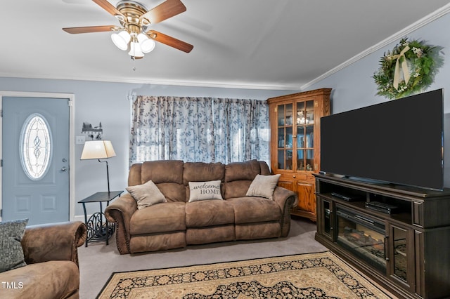 living area with ceiling fan, light carpet, and ornamental molding