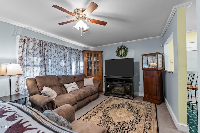 living area with a ceiling fan, crown molding, carpet, and baseboards