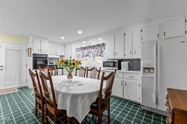 dining area with recessed lighting and dark floors