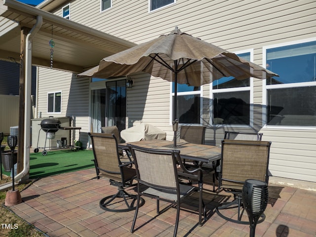 view of patio featuring outdoor dining area and grilling area