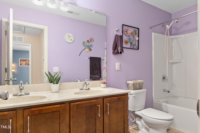 bathroom with double vanity, toilet, visible vents, and a sink