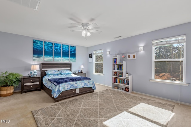 bedroom featuring a ceiling fan, carpet, and visible vents