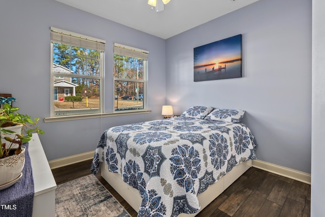 bedroom with baseboards, wood finished floors, and a ceiling fan